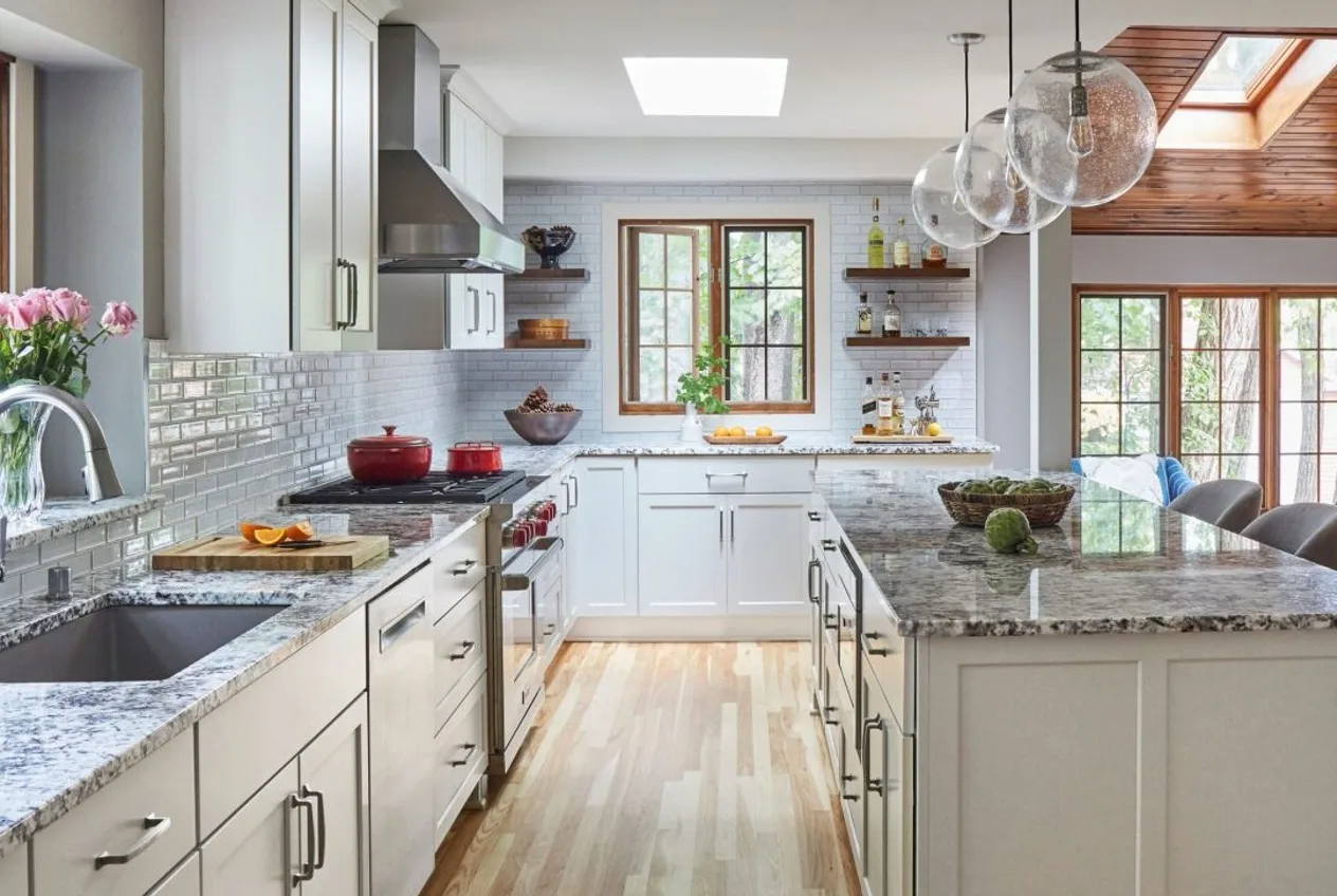 A finished kitchen remodel with granite and white cabinets