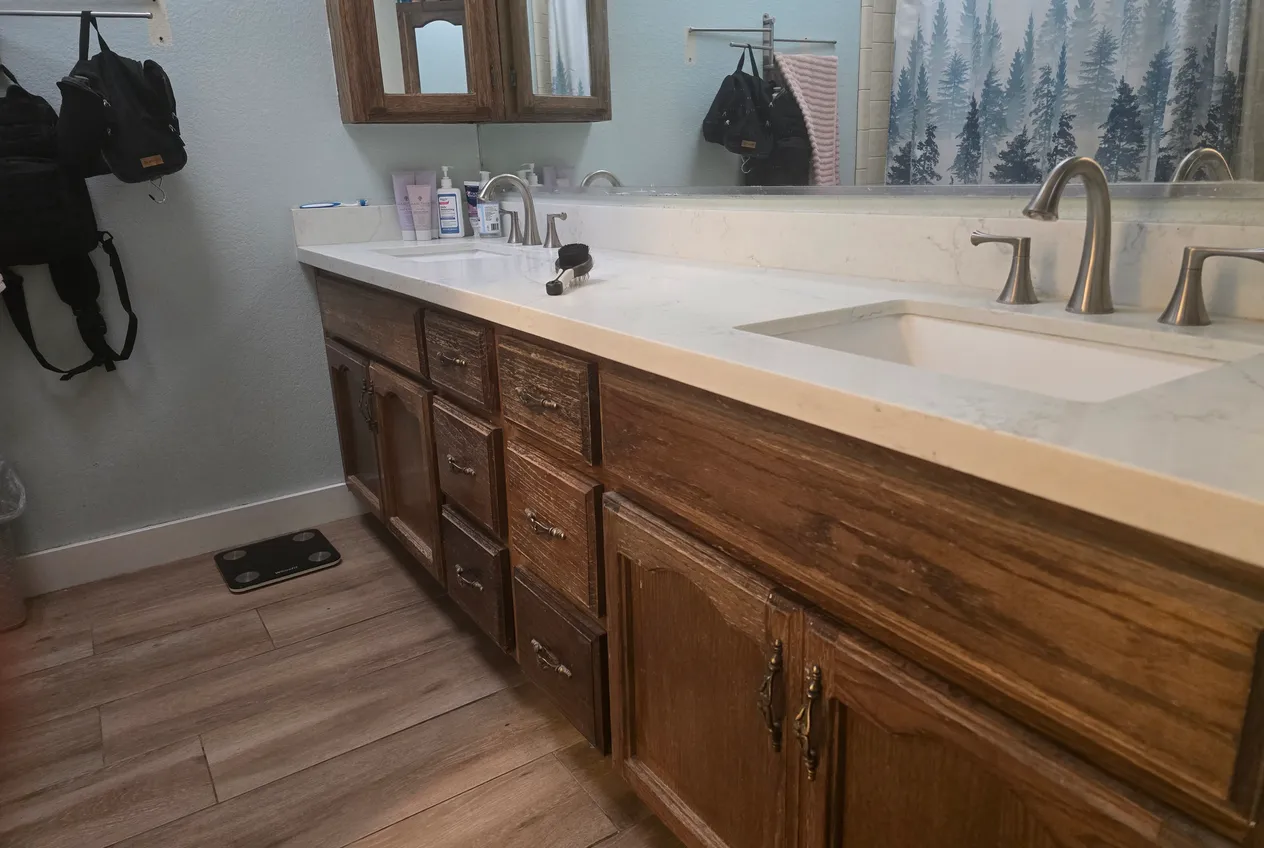 A home bathroom with a double vanity awaiting a remodel